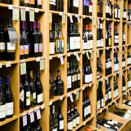 Shelves with bottles of wine in store. Shelves with bottles of wine in store.  Shelves with bottles of wine in store.