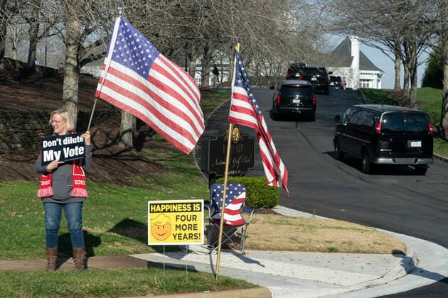 December 13, 2020, Sterling, Virginia, USA: A demonstrator shows support for United States President Donald J. Trump as he arrives at Trump National Golf Club in Sterling, VA, December 13, 2020. Credit: Pool via CNP Sterling USA - ZUMAs152 20201213_zaa_s152_002 Copyright: xChrisxKleponisx
