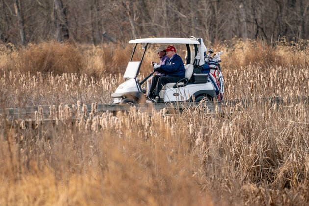 United States President Donald J. Trump drives his golf cart, number 45, as he plays golf at Trump National Golf Club in Sterling, Virginia on Sunday, December 13, 2020.  WAP20201213502 KenxCedeno