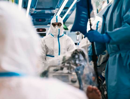 Group of professional doctors in protective uniform standing in ambulance car with equipment and preparing for patient transportation, Model released Copyright: xAparicioxFebrerx MR
