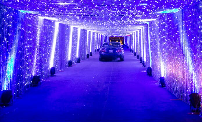 (201216) -- TORONTO, Dec. 16, 2020 -- Visitors drive their cars to go through a light tunnel at the Christmas-themed drive-thru light show Polar Drive in Toronto, Canada, Dec. 15, 2020. (Photo by Xinhua) CANADA-TORONTO-COVID-19-DRIVE-THRU-LIGHT SHOW ZouxZheng 