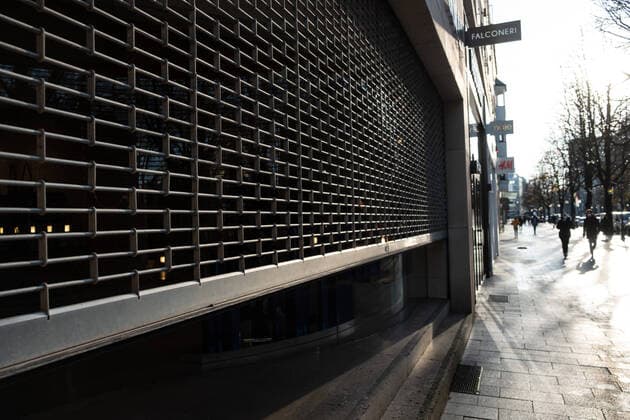 Closed shop with bars in front of the shop window on Düsseldorfs Königsallee on the first day of the lockdown EDITORIAL USE ONLY Düsseldorf North Rhine Westphalia Germany