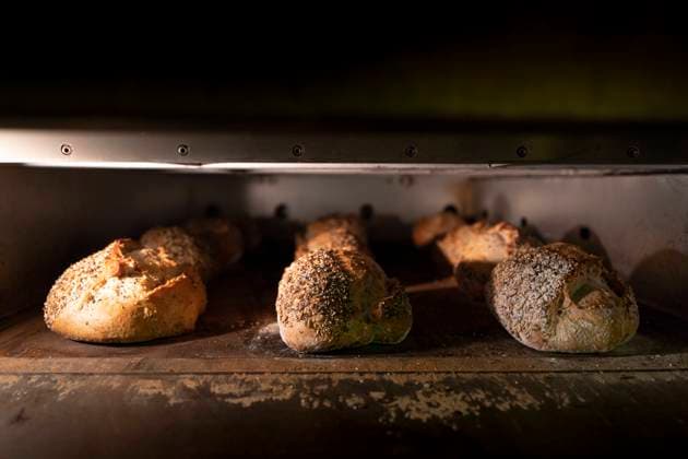 Loaves of delicious bread with crispy crust in hot oven, Model released Copyright: xDavidxAguerox MR