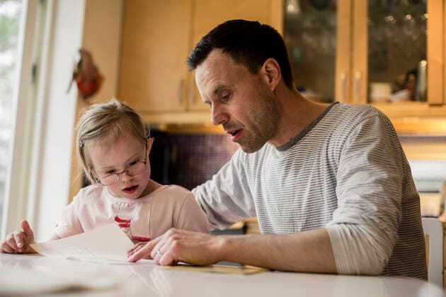 Father assisting handicapped daughter in studying at home , model released Copyright: xMaskotx , MA41225