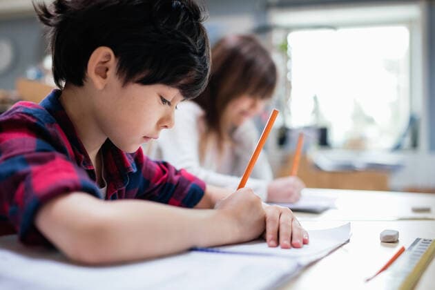 Serious students studying at desk in classroom , model released, property released Copyright: xMaskotx , MA51329
