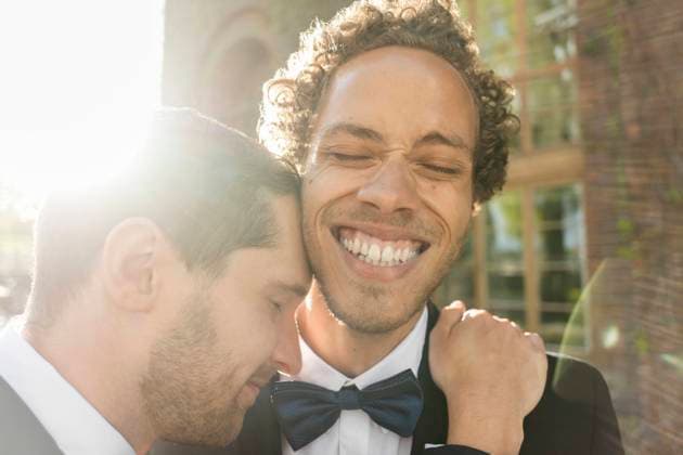 Close-up of gay man embracing cheerful newlywed partner with eyes closed , model released Copyright: xMaskotx , MA52076
