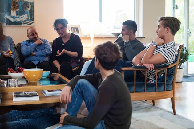 Multi-ethnic friends and family talking while sitting in living room , model released, property released Copyright: xMaskotx , MA53255