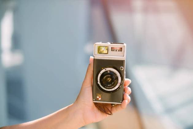Woman capturing moment taking picture on camera Copyright: xGabrielxTrujillox Model Released