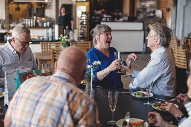 Senior couple toasting flutes while having lunch with friends in restaurant , model released, property released Copyright: xMaskotx , MA58927