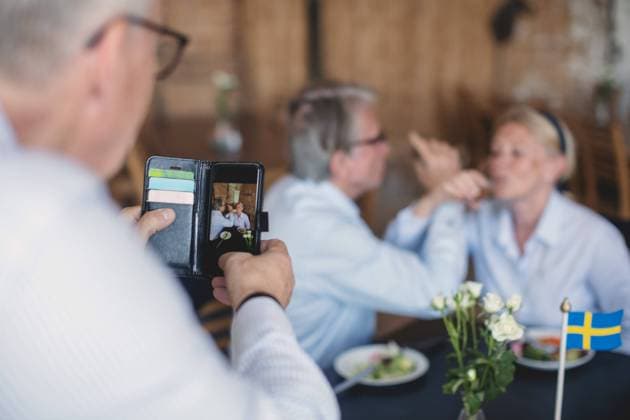 Senior man photographing couple having drinks in restaurant , model released, property released Copyright: xMaskotx , MA58930
