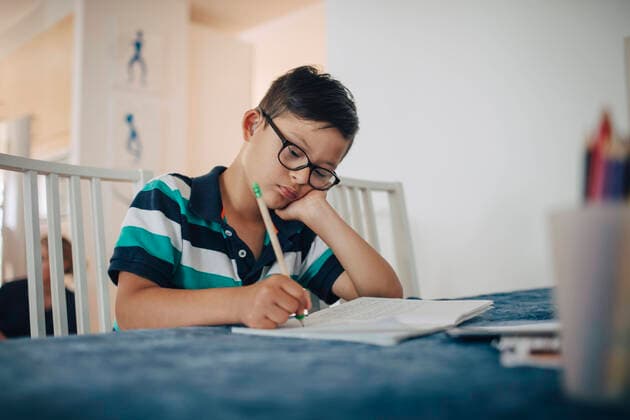 IMAGO Creative: Bildung, Schreiben Close-up of disabled boy writing on book while sitting at table , model released, property released Copyright: xMaskotx , MA59891