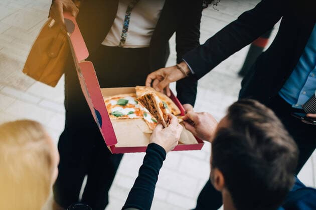 High angle view of business colleagues are eating pizza from box in city , model released Copyright: xMaskotx , MA60114