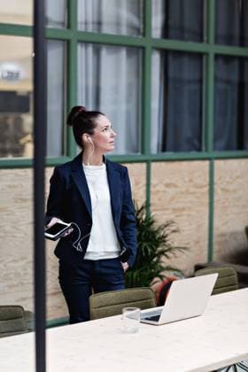 Businesswoman talking through headphones on mobile phone by table at office , model released, property released Copyright: xMaskotx , MA62983