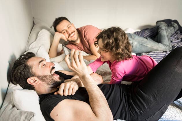 Cheerful fathers playing with daughter while lying on bed at home , model released, property released Copyright: xMaskotx , MA64193