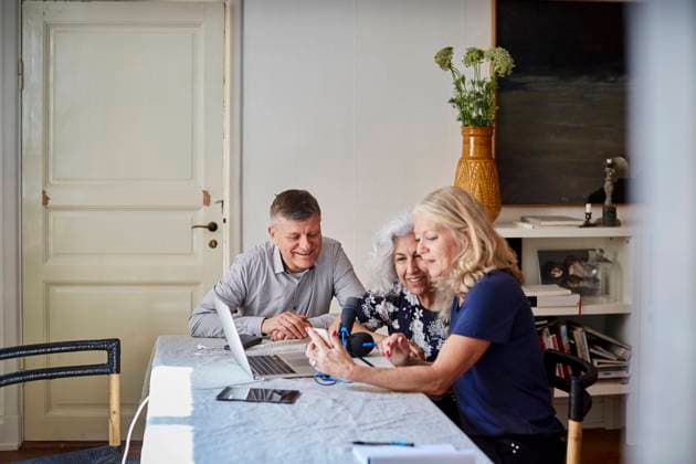Happy senior male and females vlogging at table in living room , model released, property released Copyright: xMaskotx , MA65681