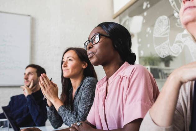 Creative business people listening while sitting in board room during meeting , model released, property released Copyright: xMaskotx , MA67809