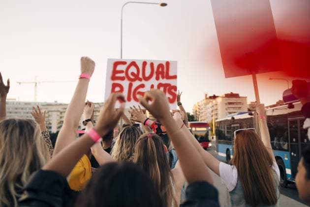 IMAGO Creative: 2021 Trends Rear view of women with banners marching for equal rights in city , model released Copyright: xMaskotx , MA69834
