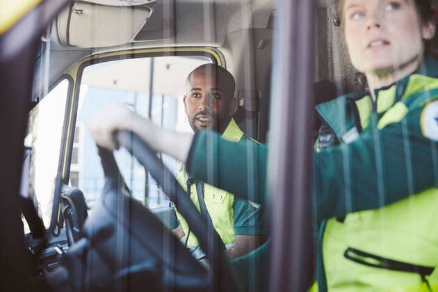 Male and female paramedics looking from ambulance window , model released Copyright: xMaskotx , MA72673