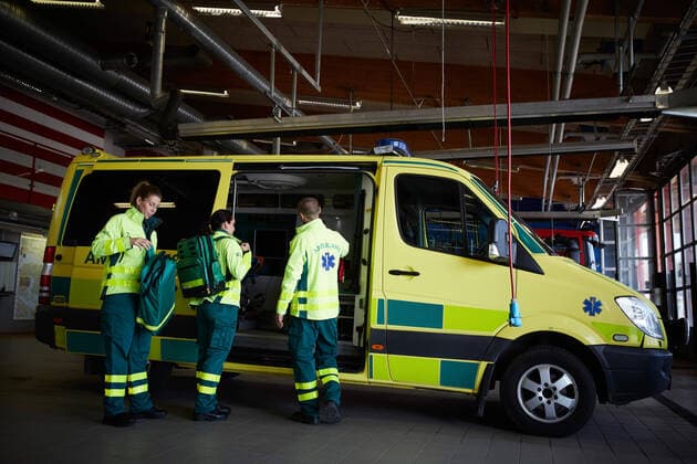 IMAGO Creative: Lokalhelden - Gesundheits- und Rettungskräfte Full length of paramedics getting ready outside ambulance in parking lot , model released, property released Copyright: xMaskotx , MA73416