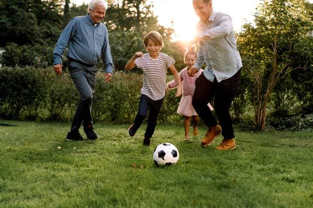 Full length of multi-generation family playing soccer in backyard , model released, property released Copyright: xMaskotx , MA76081