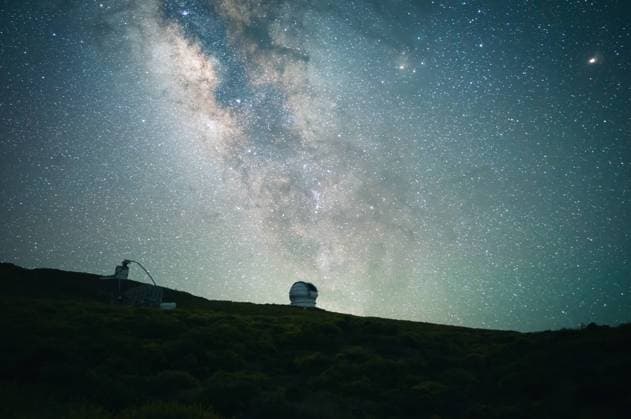Low angle of glowing starry sky with Milky Way over forest in highland area in long exposure, Model released Copyright: xJavierxMartinezx MR