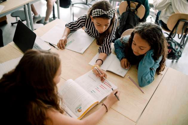 High angle view of female students studying from book in classroom , model released, property released Copyright: xMaskotx , MA77665