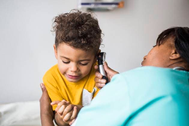 Female pediatrician examining boy s ear in medical clinic , model released, property released Copyright: xMaskotx , MA78674