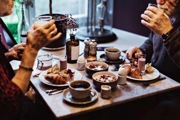 Midsection of senior couple having breakfast at table in hotel Sweden, Stockholm, model released, property released Copyright: xMaskotx , MA79298
