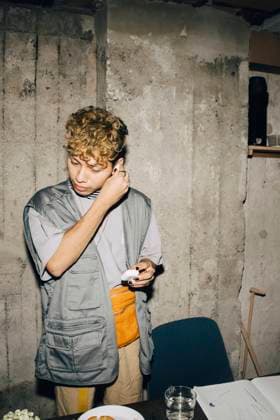 Businessman wearing in-ear headphones against wall in workplace Sweden, Stockholm, model released, property released Copyright: xMaskotx , MA79579