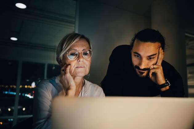 Multi-ethnic colleagues staring at laptop during meeting in office Sweden, Stockholm, model released, property released Copyright: xMaskotx , MA79735