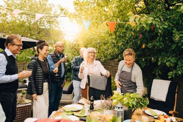 Cheerful senior friends enjoying during back yard dinner party Sweden, Stockholm, model released, property released Copyright: xMaskotx , MA80018