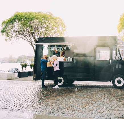 Owner talking to senior customers while standing in commercial land vehicle Sweden, Stockholm, model released, property released Copyright: xMaskotx , MA81605