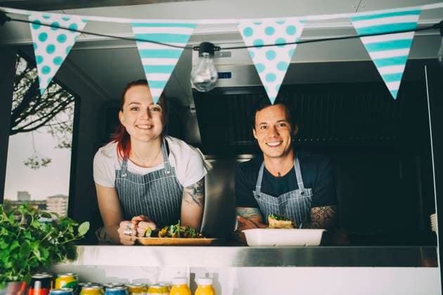 Smiling owner and assistant standing in food truck Sweden, Stockholm, model released, property released Copyright: xMaskotx , MA81616
