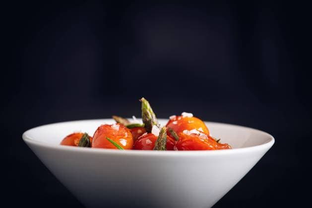 Fresh cherry tomatoes sauteed with green asparagus and rosemary Copyright: xJosxTempranox Model Released