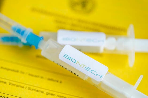 Symbol photo vaccination syringe Biontech and vaccination certificate Symbol photo of a BIONTECH vaccination syringe on a vaccination certificate The Biontech vaccine is about to be approved and released by the European Medicines Agency EMA for the vaccination of the first risk groups against the Corona virus Germany