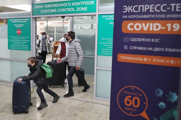 MOSCOW REGION, RUSSIA â€“ DECEMBER 21, 2020: Travellers in face masks are seen in the arrivals hall at the Sheremetyevo International Airport after an Aeroflot SU2579 flight from London. Russia has announced that from 22 December 2020 it is suspending flights to and from the United Kingdom where a new strain of novel coronavirus causing COVID-19 has been identified. Mikhail Tereshchenko TASS  TS0F2624