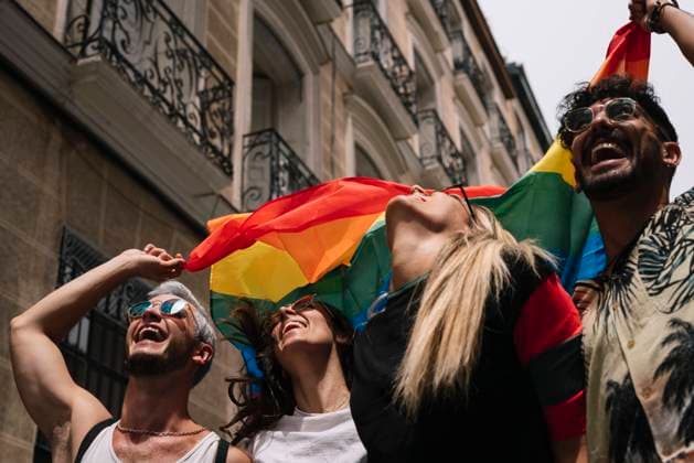 Group of friends with a flag of gay pride in the city of Madrid Copyright: xJosexLuisxCarrascosax Model Released