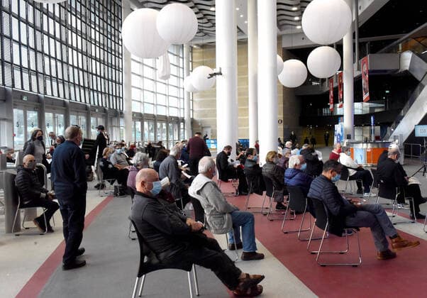 Israelis wait to be injected with the Pfizer-BioNTech COVID-19 vaccine in the Pais Arena in Jerusalem, on Tuesday, December 22, 2020. The Pais Arena was converted into a COVID-19 vaccination center as Israel started a mass coronavirus vaccine campaign for elderly citizens 60 years and up.  JER2020122315 DEBBIExHILL