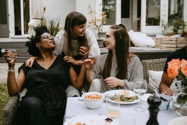 Smiling female friends talking while enjoying during social gathering Sweden, Stockholm, model released, property released Copyright: xMaskotx , MA83417