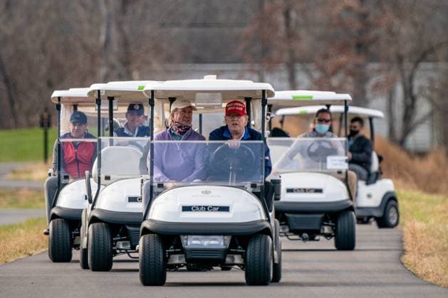 President Donald J. Trump drives his golf cart, number 45, as he plays a round of golf at Trump National Golf Club in Sterling, Virginia, on Sunday, December 13, 2020.  POY2020DC201 KENxCEDENO