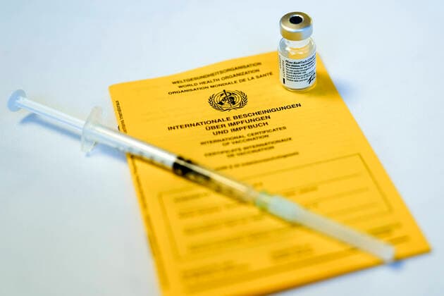 Vaccination start in Cologne first residents of nursing homes are vaccinated symbol picture, symbol photo vaccination passport with an ampoule of Biontech Pfizer vaccine and syringe during the first vaccination in nursing homes Cologne North Rhine Westphalia Germany