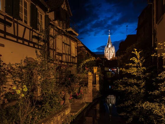 Church St. Peter et Paul in Wissembourg, France on a cloudy night, blue sky, canal Wissembourg France