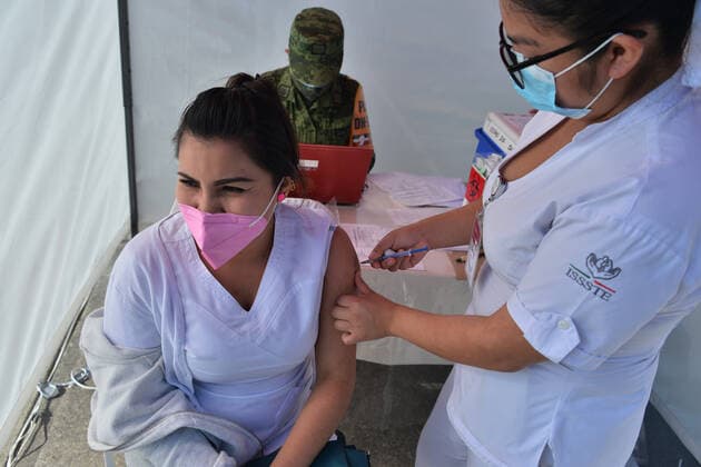 Mexico: Vaccination against Covid-19 MEXICO CITY, MEXICO - DECEMBER 30: A nurse administrates the Pfizer-BioNTech COVID-19 vaccine to a person during the vaccinations against Covid for health workers at tents installed for the vaccination campaign of Covid-19 inside Military Camp 1A on December 30, 2020 in Mexico City, Mexico **World Rights ** Mexico City Mexico Copyright: CarlosxTischler