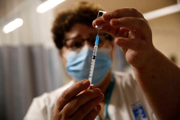 (201231) -- TEL AVIV, Dec. 31, 2020 -- An Israeli medical worker prepares a COVID-19 vaccine at the Assaf Harofeh Medical Center in Tel Aviv, Israel, on Dec. 30, 2020. The total number of vaccines given in Israel since the start of the vaccination campaign on Dec. 20 has surpassed half a million, the state s Ministry of Health said on Wednesday. (Photo by Xinhua) ISRAEL-TEL AVIV-COVID-19-VACCINE GilxCohenxMagen 