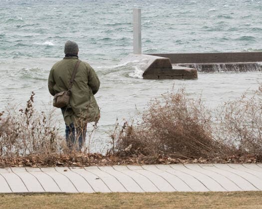 January 1, 2021, Toronto, Ontario, Canada: A man is drawn to the second mysterious metal monolith appearing on a breakwall off Torontos shoreline New Years Day. The structure was anonymously and strategically placed in direct line of sight of the first column. Toronto Canada - ZUMAs109 20210101_zaf_s109_002 Copyright: xChristopherxDrostx