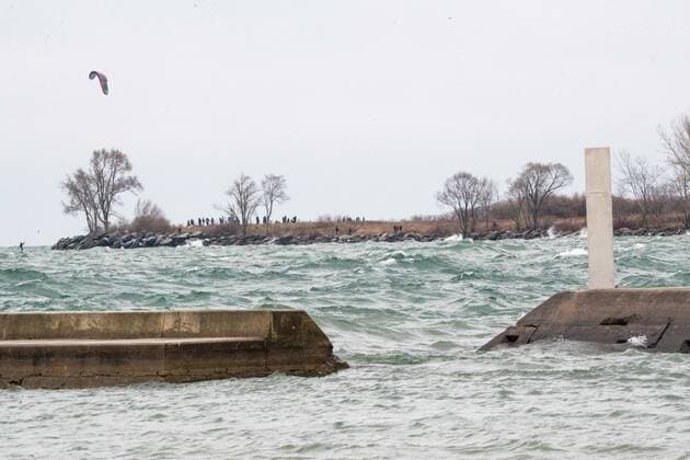 January 1, 2021, Toronto, Ontario, Canada: High winds and waves test a windsurfer and a second mysterious metal monolith structure on Torontos shoreline on New Years Day. The structure was anonymously and strategically placed in direct line of sight of the first column which appeared 24 hours earlier. Toronto Canada - ZUMAs109 20210101_zaf_s109_010 Copyright: xChristopherxDrostx