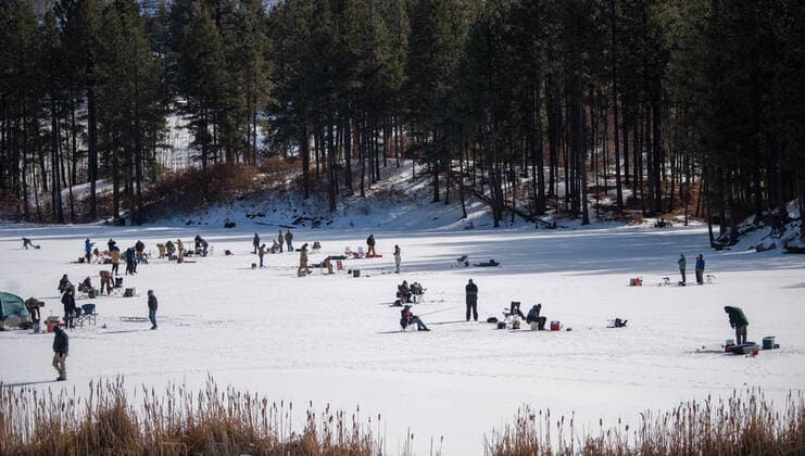 January 2, 2021, Fenton Lake, USA: .People kicked off the new year by going ice fishing at Fenton Lake in the Jemez mountains Saturday morning. This was the first day the lake opened for ice fishing. Due to recent cold weather, the lakes ice thickness is now at minimum standards for this access according to New Mexico State Parks officials. Pictured is a group of fishermen in the middle of the lake. Close to 80 folks came out early this morning to try their luck. .Jemez Mountains, New Mexico ABQ Journal Fenton Lake USA - ZUMAab1_ 20210102_zaf_ab1_002 Copyright: xRobertoxE.xRosalesx