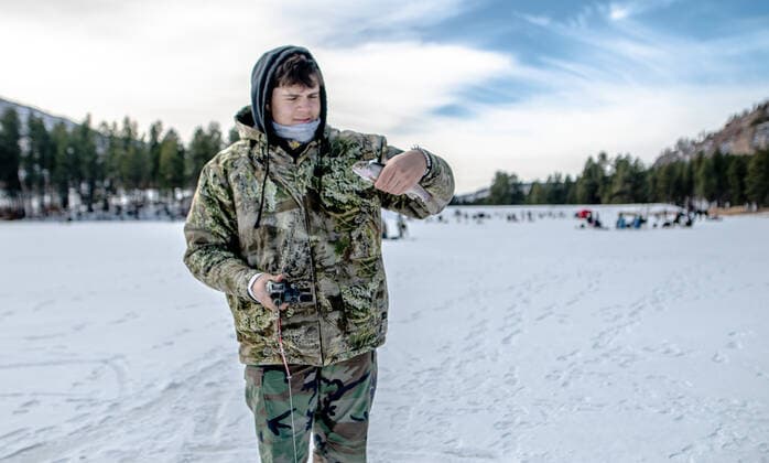 January 2, 2021, Fenton Lake, USA: .People kicked off the new year by going ice fishing at Fenton Lake in the Jemez mountains Saturday morning. This was the first day the lake opened for ice fishing. Due to recent cold weather, the lakes ice thickness is now at minimum standards for this access according to New Mexico State Parks officials. Pictured is Alexander Dye(Cq),16 of Albuquerque pulling in a Rainbow trout. Close to 80 folks came out early this morning to try their luck. .Jemez Mountains, New Mexico ABQ Journal Fenton Lake USA - ZUMAab1_ 20210102_zaf_ab1_003 Copyright: xRobertoxE.xRosalesx