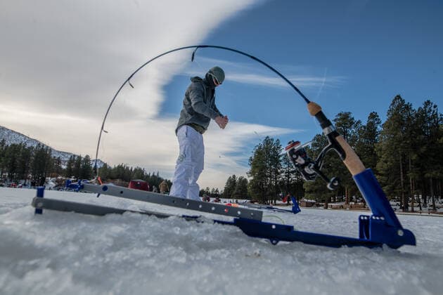 January 2, 2021, Fenton Lake, USA: .People kicked off the new year by going ice fishing at Fenton Lake in the Jemez mountains Saturday morning. This was the first day the lake opened for ice fishing. Due to recent cold weather, the lakes ice thickness is now at minimum standards for this access according to New Mexico State Parks officials. Pictured is Matt Tamplen(Cq) of Rio Rancho drops a line in a hole. Close to 80 folks came out early this morning to try their luck. .Jemez Mountains, New Mexico ABQ Journal Fenton Lake USA - ZUMAab1_ 20210102_zaf_ab1_005 Copyright: xRobertoxE.xRosalesx