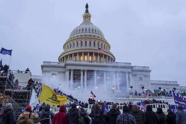 Proud Boys and pro-Trump supporters gather at the U.S. Capitol to protest against the Electoral College vote count that would certify President-elect Joe Biden as the winner in Washington, DC on Wednesday, January 6, 2021. Under federal law, Jan. 6 is the date Electoral College votes determining the next president are counted in a joint session of Congress.  WAP20210106204 LeighxVogel